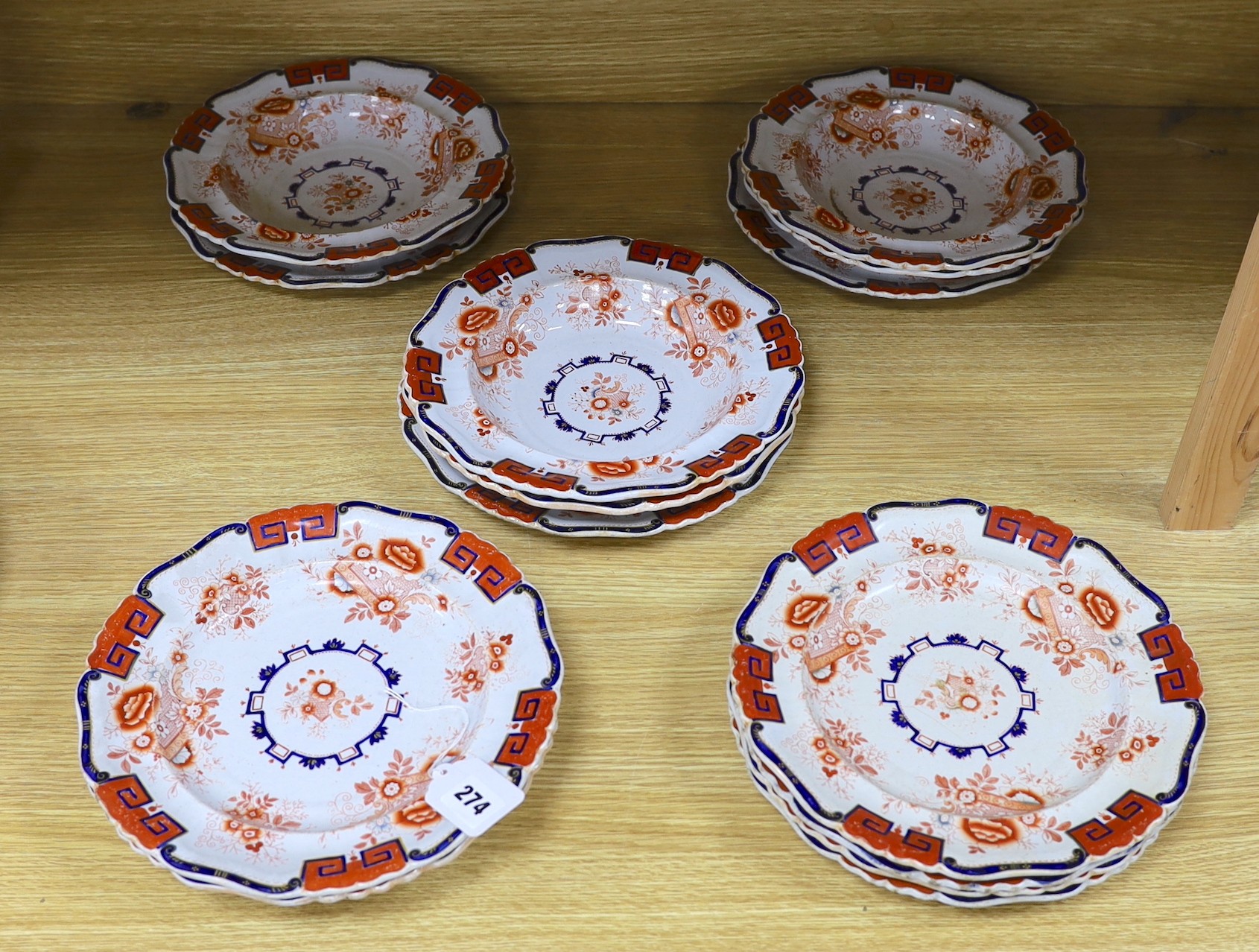 Eight early 19th century English 'Stone China' circular plates with cream, red and white decoration and six matching soup bowls